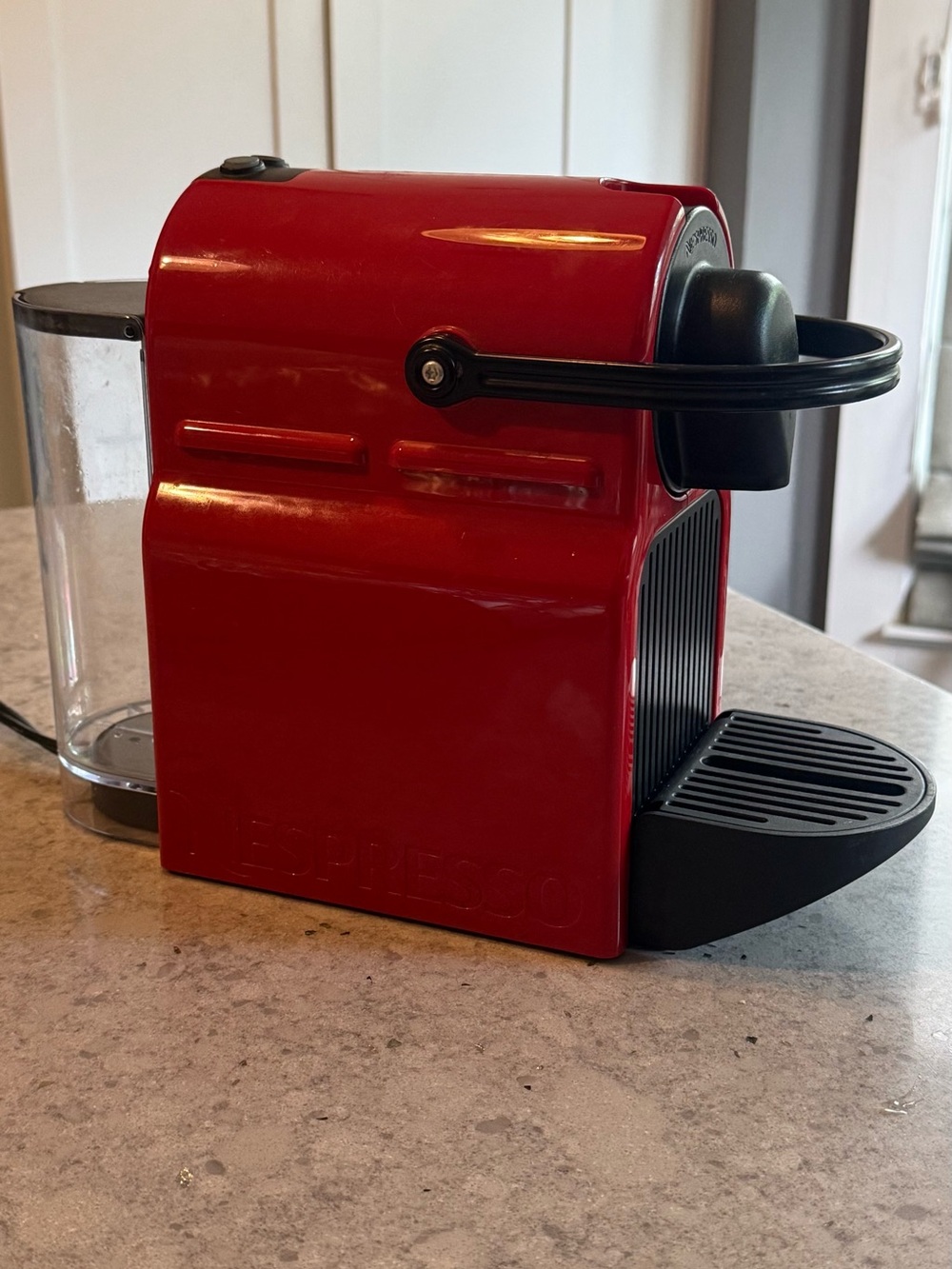 Nespresso Red Single-Serve Espresso Machine with Black Accents.